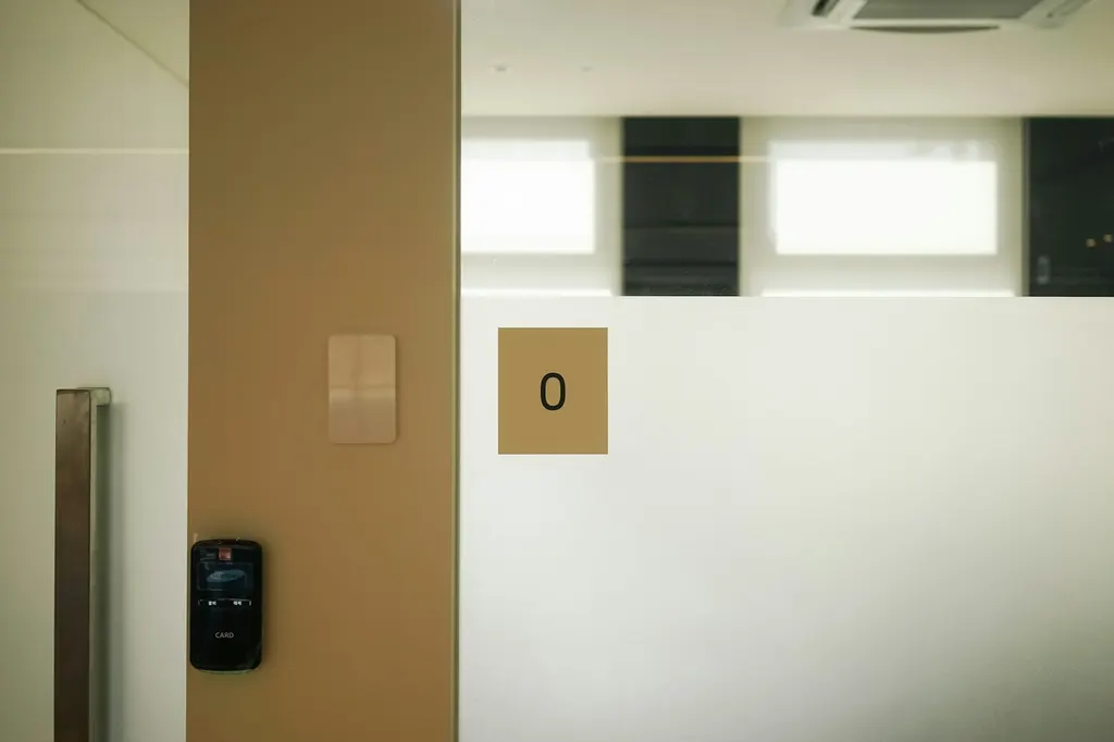 A room with a door and a sign on the wall